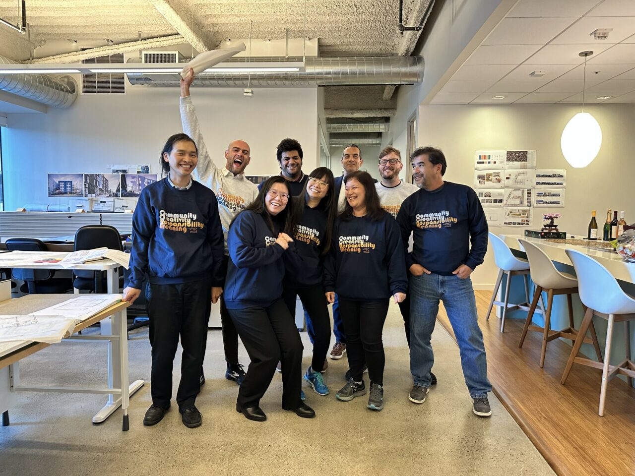 M W A's San Francisco office wearing sweatshirts with their values on them.